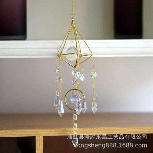 Decorative crystal hanging ornament with gold frame on a neutral background